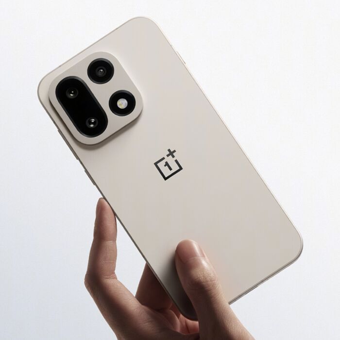 OnePlus 15 in Sand Storm color being held in a hand, demonstrating its in-hand feel, flat-edge metal frame, and the new square camera design.